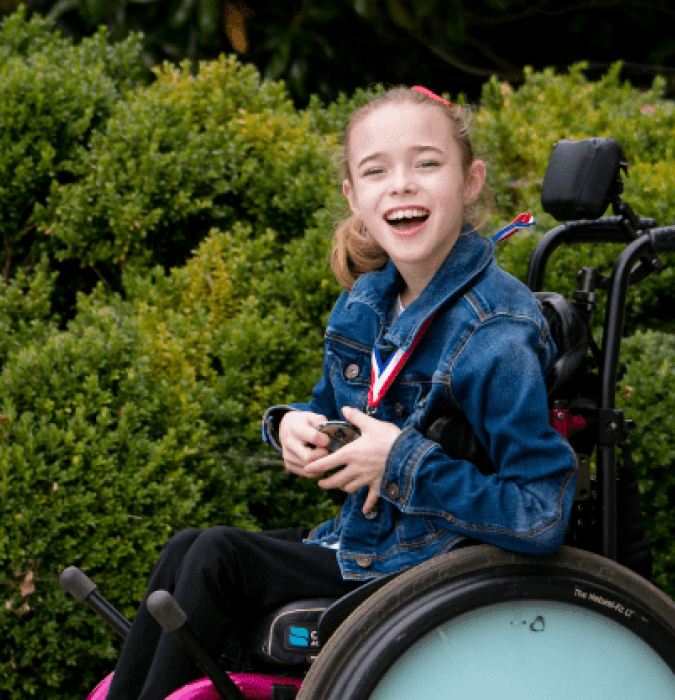 Madison Rogers, a young girl using a motorized wheelchair