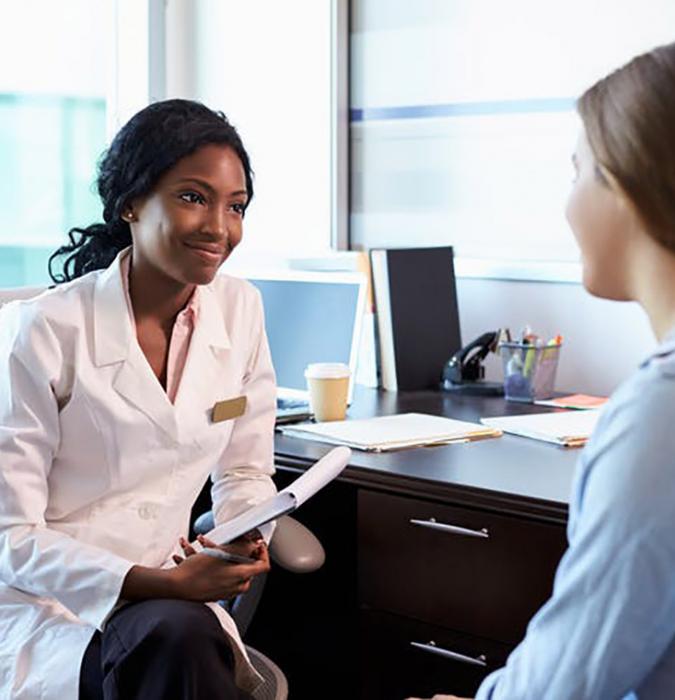 Young woman talking with doctor about options