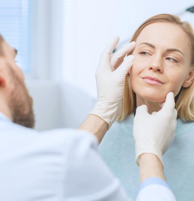 Plastic surgery provider examining a patient's face for cosmetic surgery