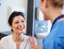 Caregiver talking with a smiling patient