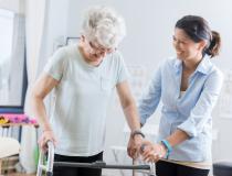 Elderly woman doing rehabilitation exercises with Caregiver