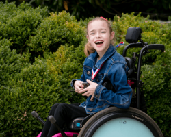 Madison Rogers, a young girl using a motorized wheelchair