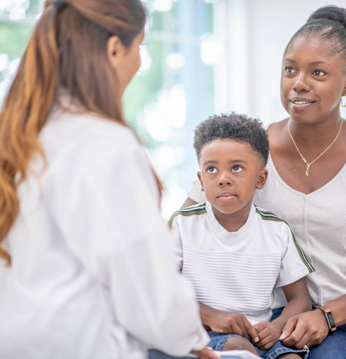 Mother and son speak with a behavior health provider.